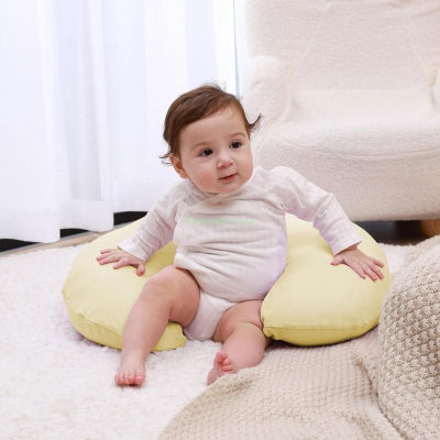 Bebe sur coussin d allaitement Nidage jaune