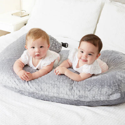 Des jumeaux riant dans un coussin dallaitement Brefi